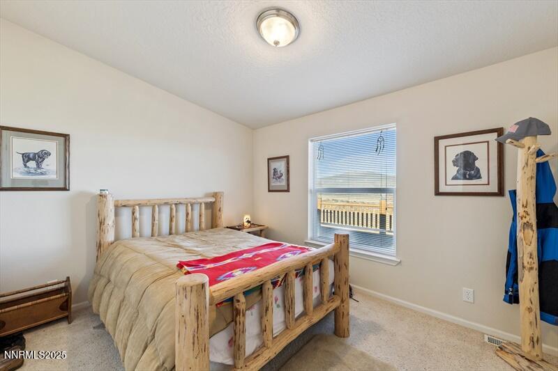 231 Atcheson Yerington, NV 89447 - Photo 22 of 30 a bedroom with a bed and a window
