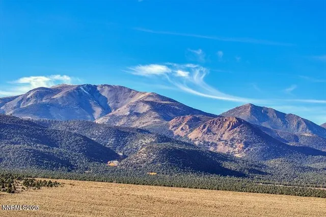 a living room with furniture kitchen view and a large window