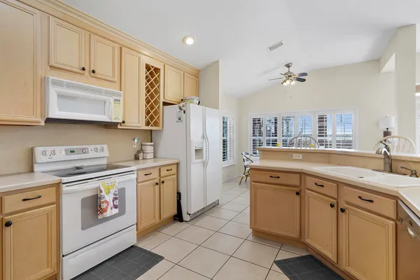 a kitchen with a sink cabinets and appliances