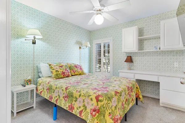 a bedroom with a bed and a painting on the wall