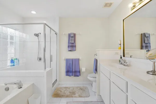 a bathroom with a tub sink and shower