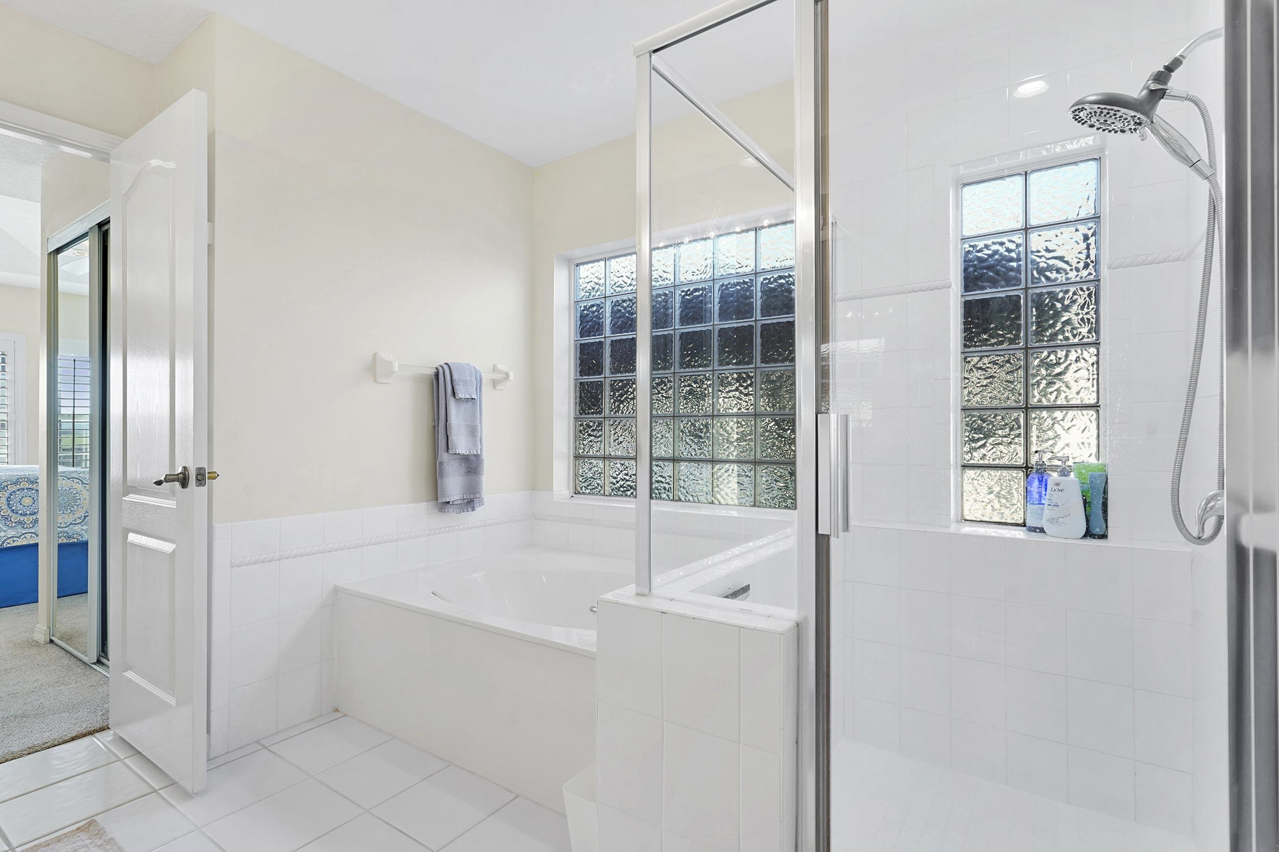 338 South Ocean Trace Road St. Augustine, FL 32080 - Photo 29 of 41 a bathroom with a tub sink and shower