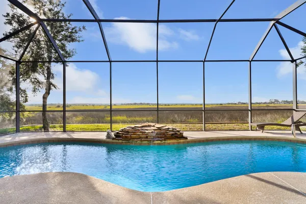 a view of a swimming pool with outdoor seating