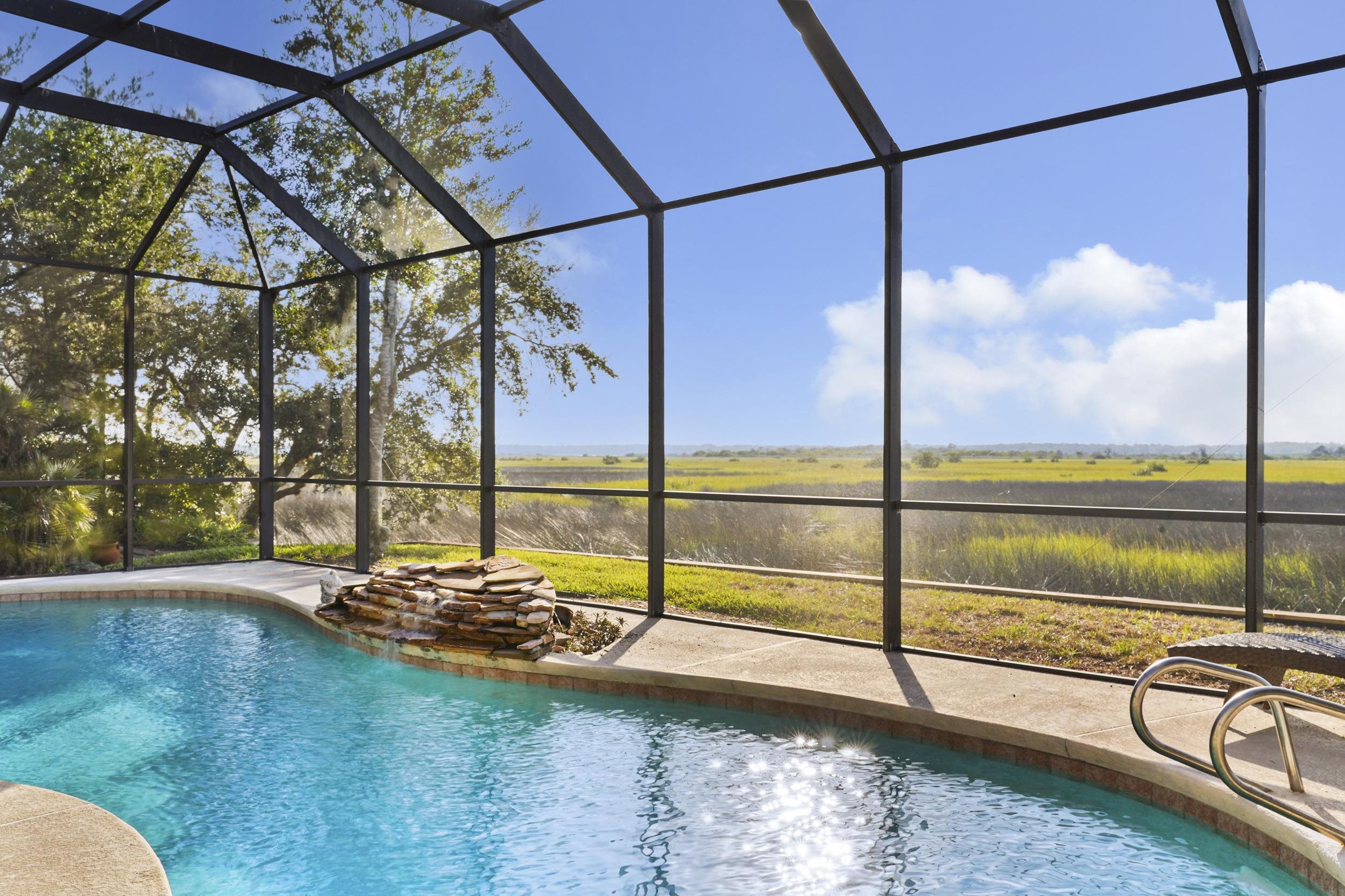 338 South Ocean Trace Road St. Augustine, FL 32080 - Photo 34 of 41 a view of a swimming pool with a lounge chairs