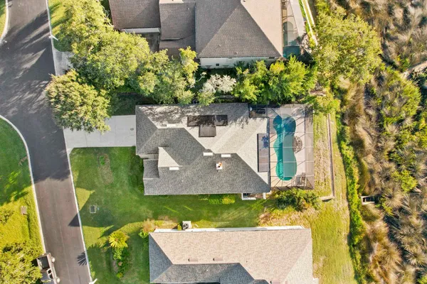 a front view of a house with a yard and fountain
