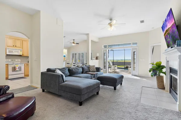a living room with furniture a flat screen tv and a fireplace
