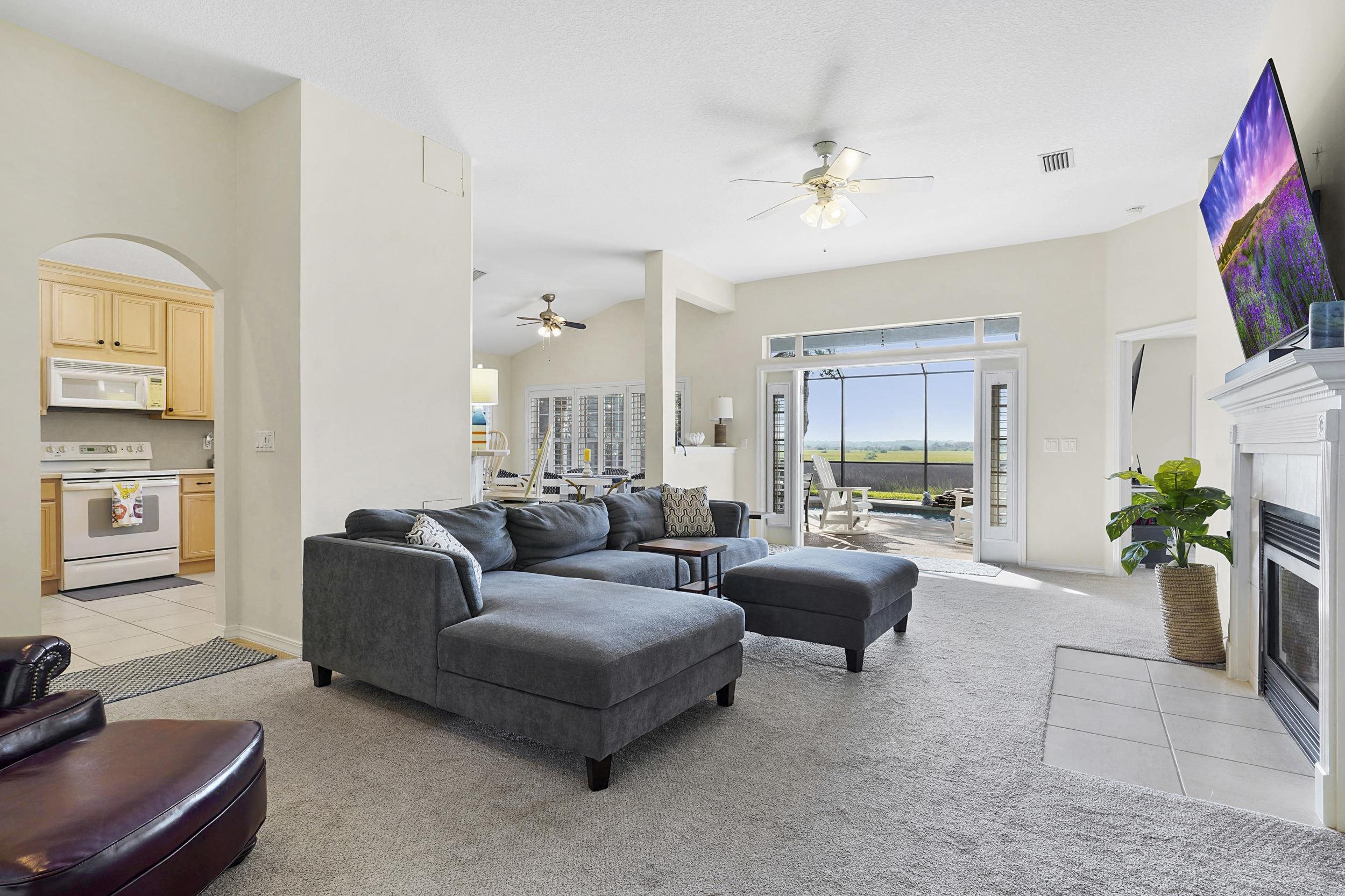 338 South Ocean Trace Road St. Augustine, FL 32080 - Photo 9 of 41 a living room with furniture and a flat screen tv