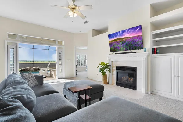 a living room with furniture a flat screen tv and a fireplace