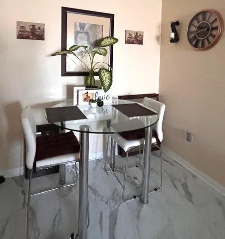 a view of a dining room with furniture and window
