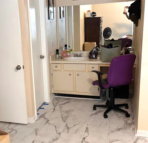 a bedroom with a bed window and a television