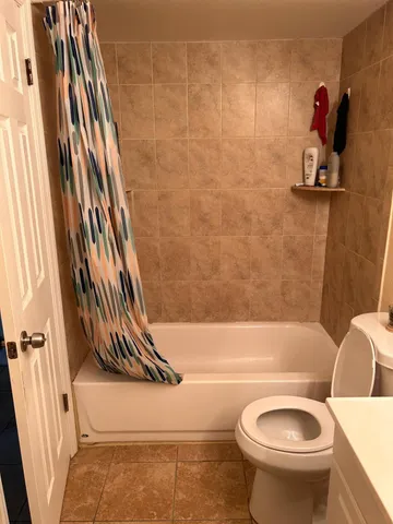 a bathroom with a sink mirror and toilet