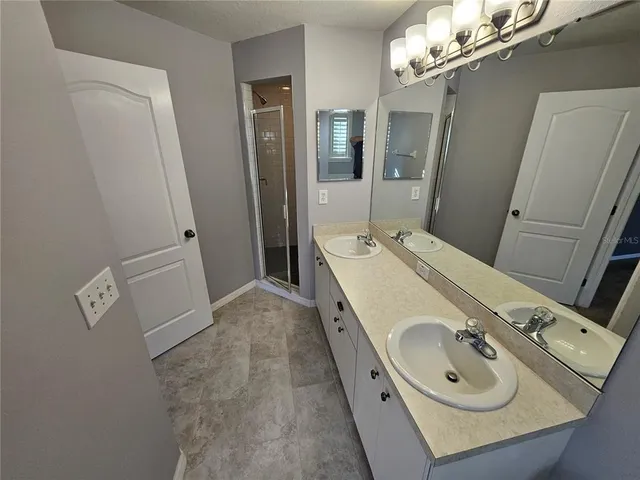 a bathroom with a sink and mirror