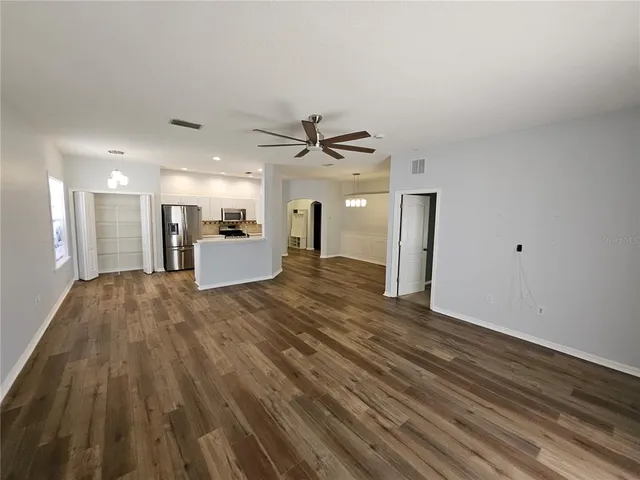 a view of a hallway with a kitchen