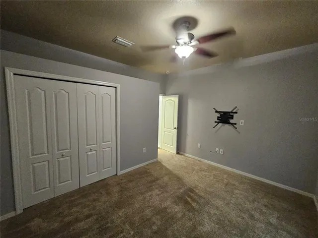 a view of a chandelier fan and entryway