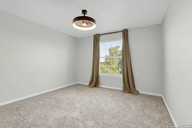 a bathroom with a sink a toilet a mirror and shower curtain