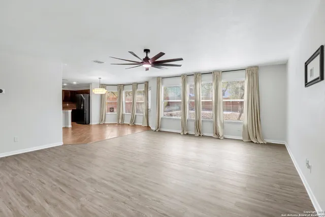 a view of a kitchen with a sink and a refrigerator