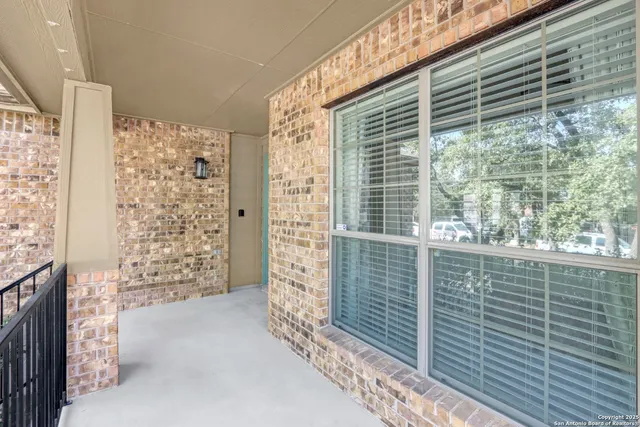 a view of a livingroom with wooden floor and a ceiling fan