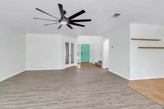 an empty room with windows and entrance