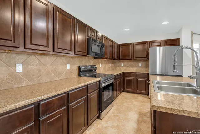 a kitchen with granite countertop a sink and stove