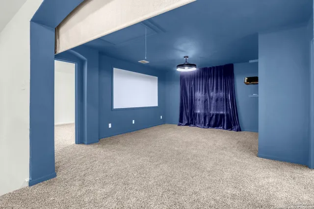 an empty room with windows and entrance