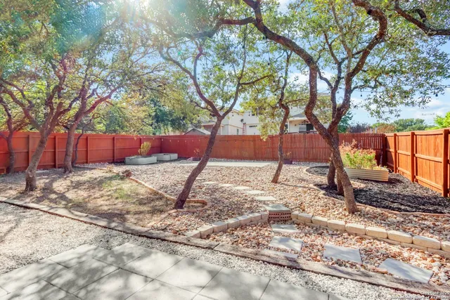 a view of a backyard with sitting area