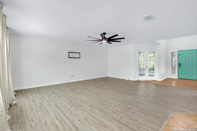 a view of a livingroom with a hardwood floor and a ceiling fan