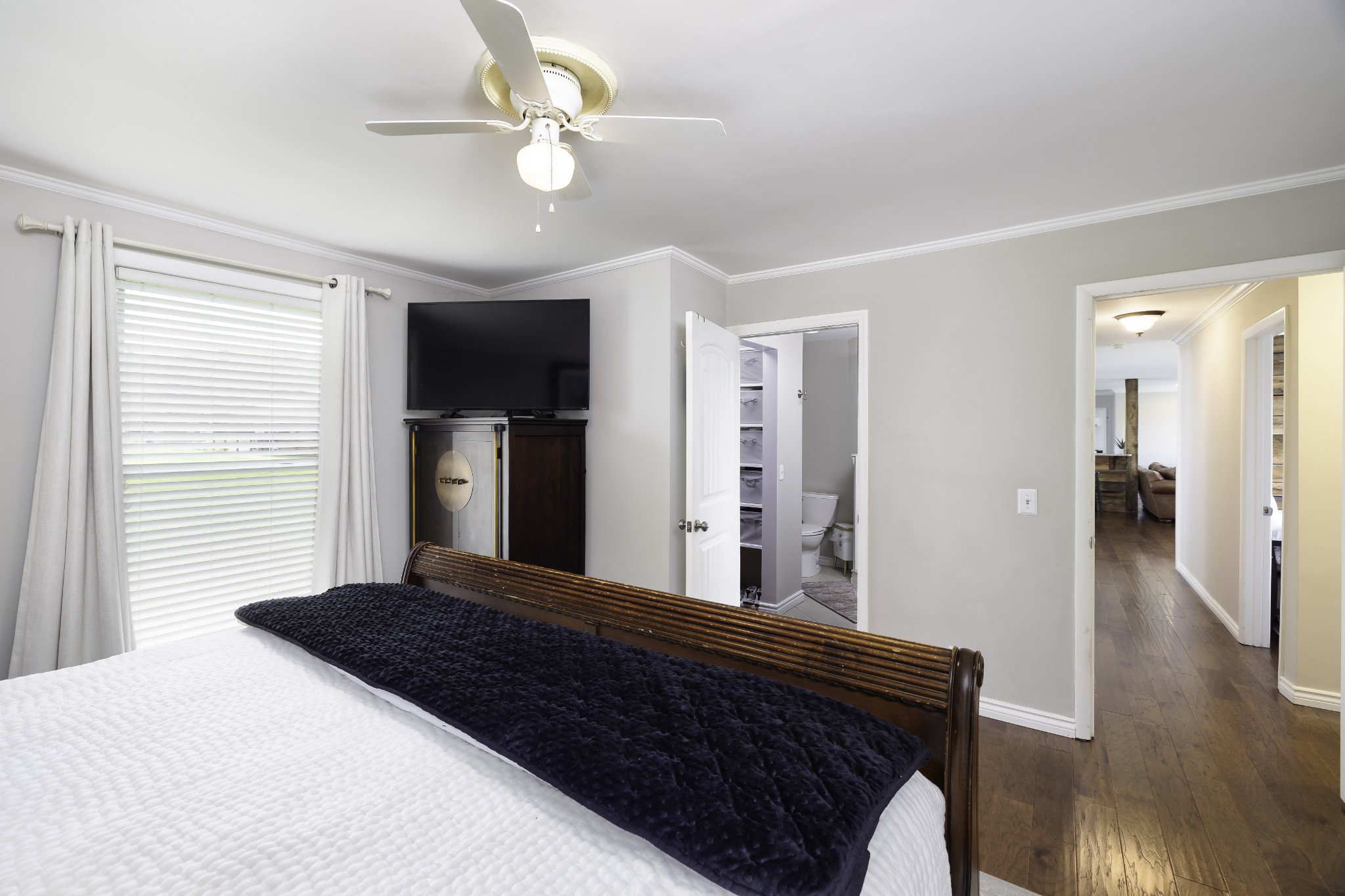 6865 Flat Creek Road College Grove, TN 37046 - Photo 39 of 66 a bedroom with a bed and a chandelier