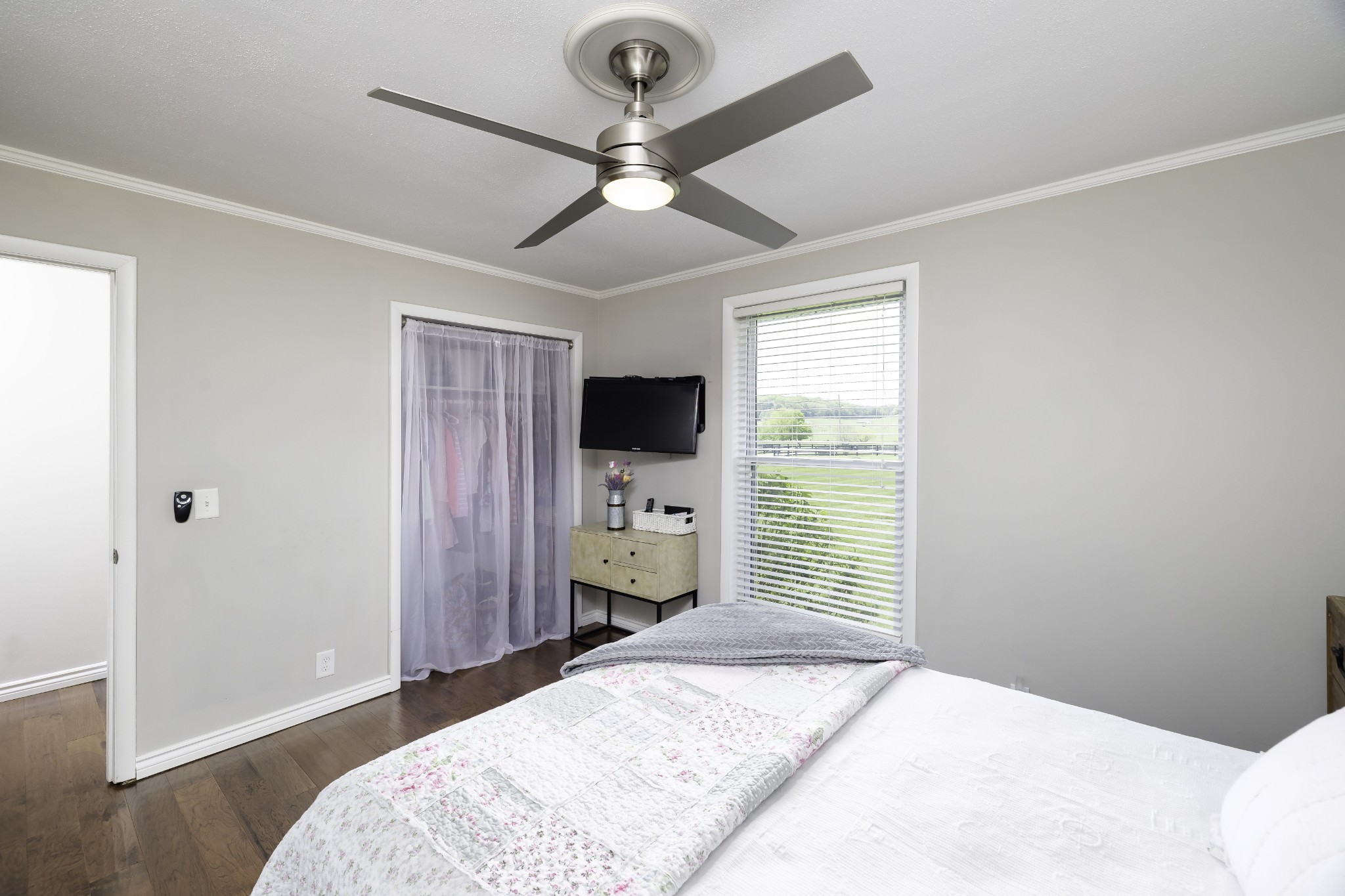 6865 Flat Creek Road College Grove, TN 37046 - Photo 45 of 66 a bedroom with a bed and a flat tv screen on the dresser