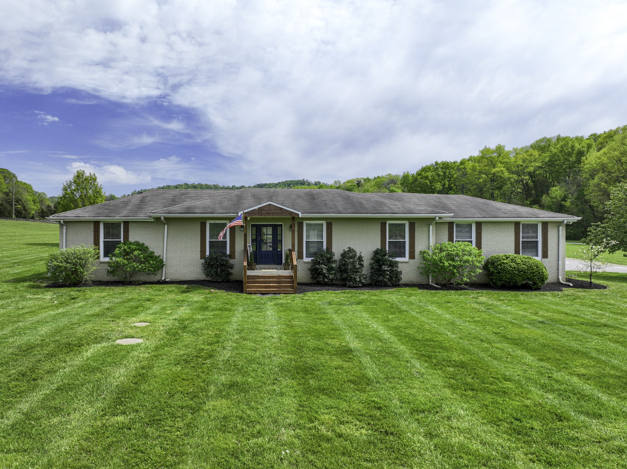 6865 Flat Creek Road College Grove, TN 37046 - Photo 9 of 66 a front view of a house with a garden