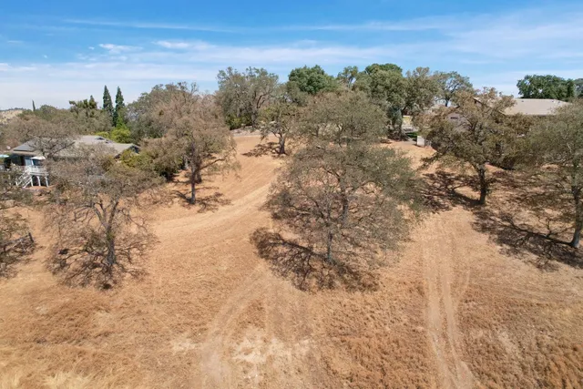 a view of a yard covered with snow in front of house