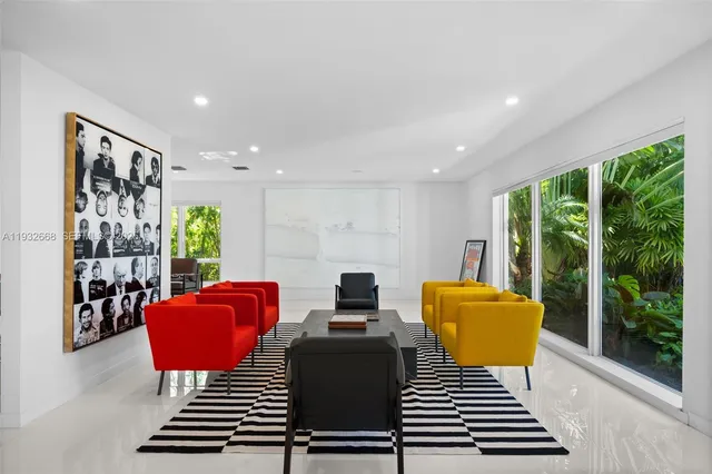 a living room with furniture a rug and white walls