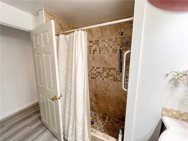 a bathroom with a shower and a curtain
