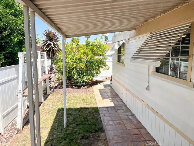 a view of a patio with table and chairs and potted plants