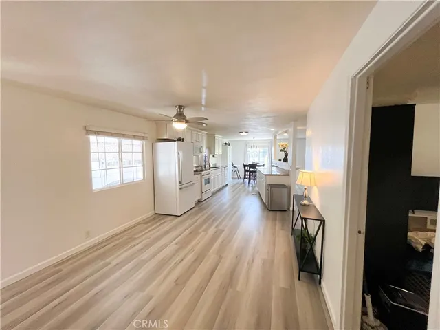 a view of a living room hardwood floor and a kitchen