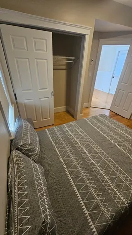 a bedroom with a bed and a mirror