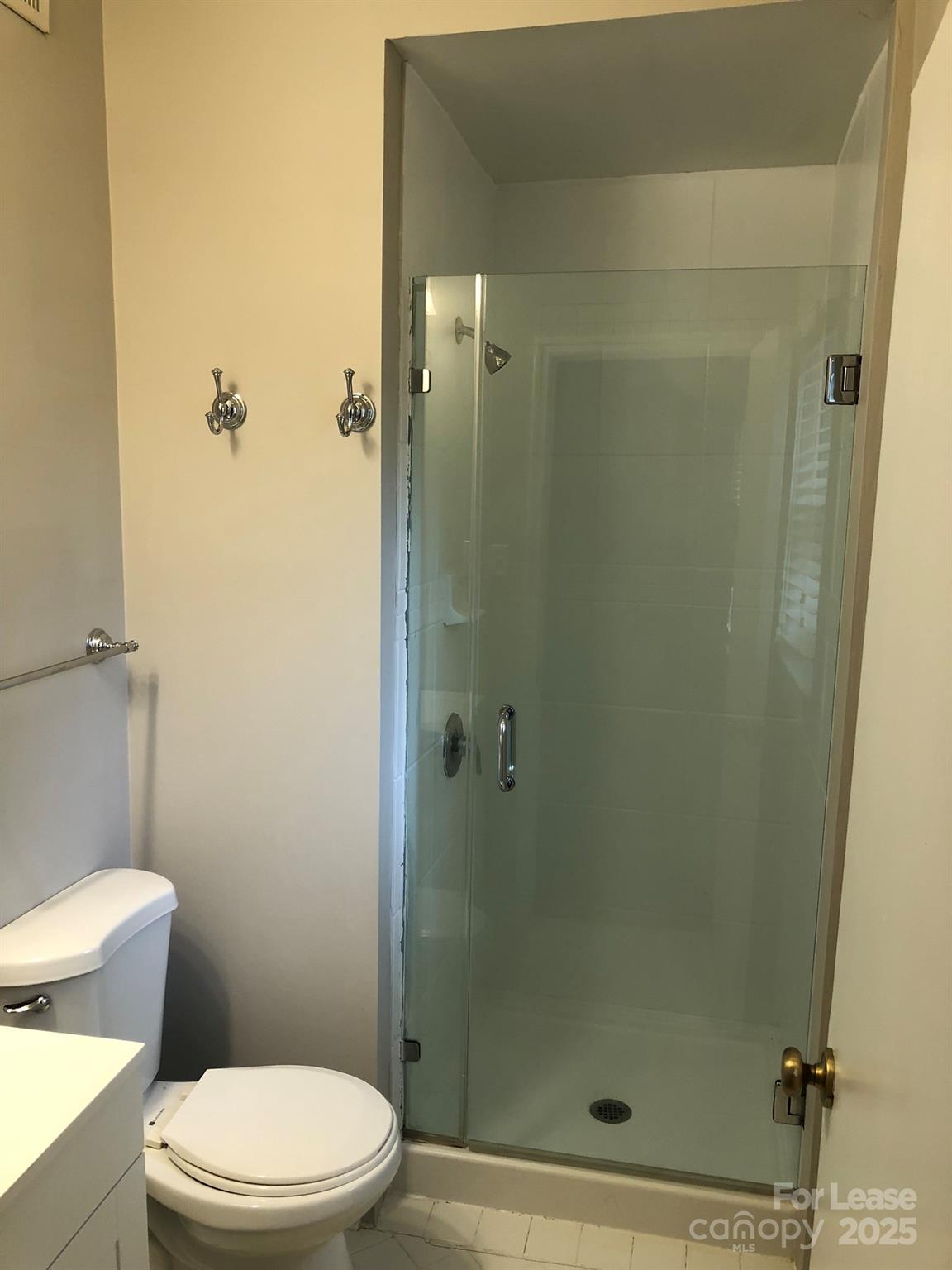 5925 Quail Hollow Road, Unit D Charlotte, NC 28210 - Photo 14 of 17 a white toilet sitting next to a bathroom sink