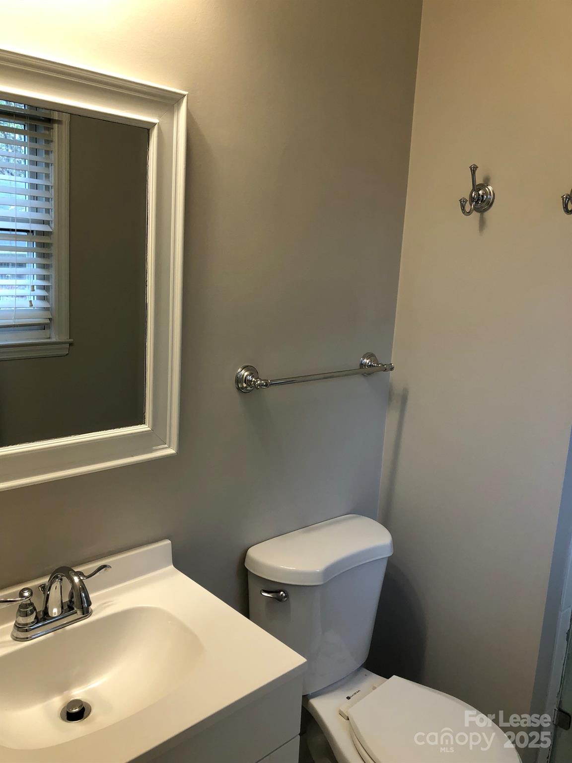 5925 Quail Hollow Road, Unit D Charlotte, NC 28210 - Photo 15 of 17 a white toilet sitting next to a bathroom sink