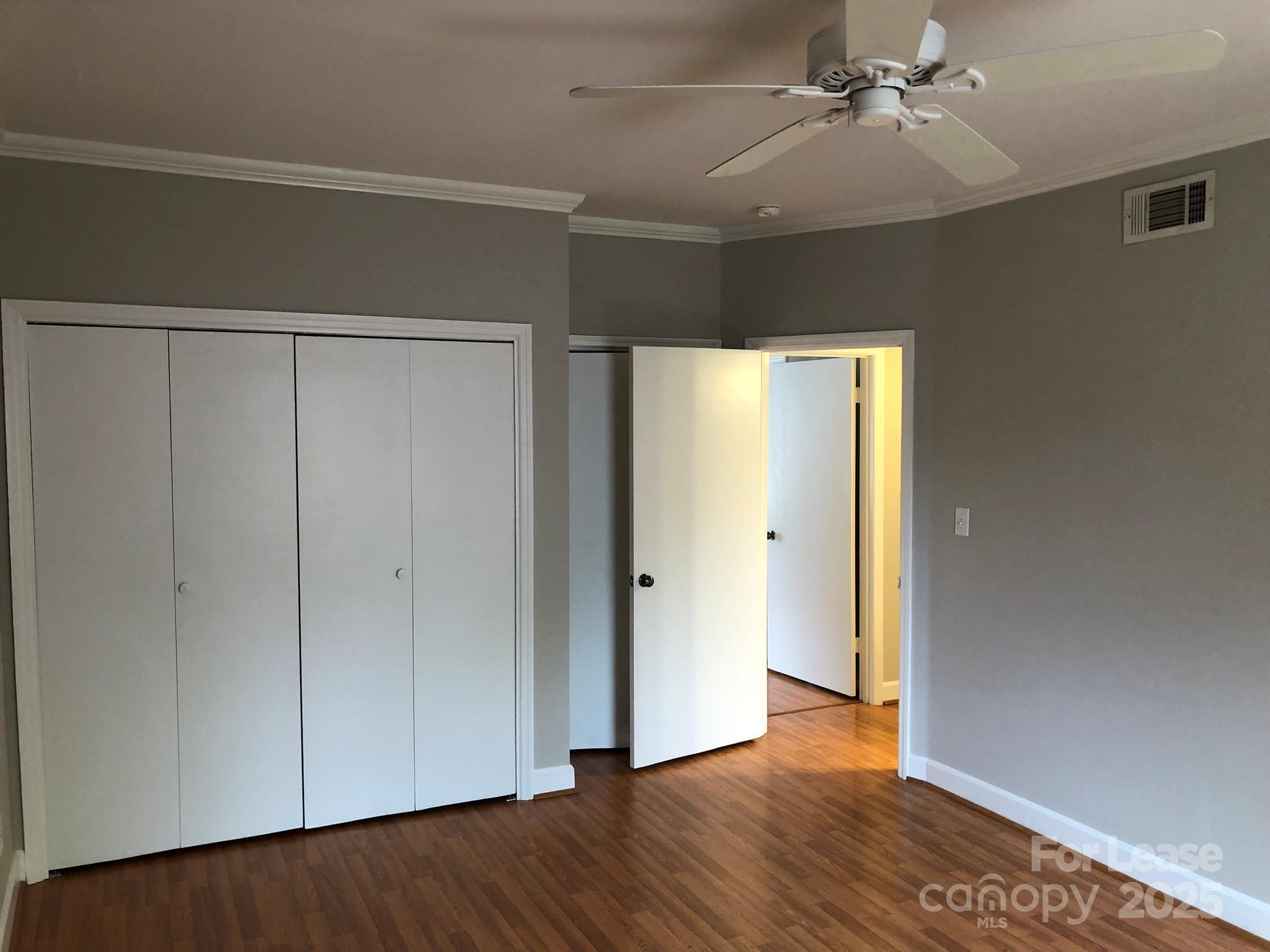 5925 Quail Hollow Road, Unit D Charlotte, NC 28210 - Photo 16 of 17 a view of an empty room with wooden floor