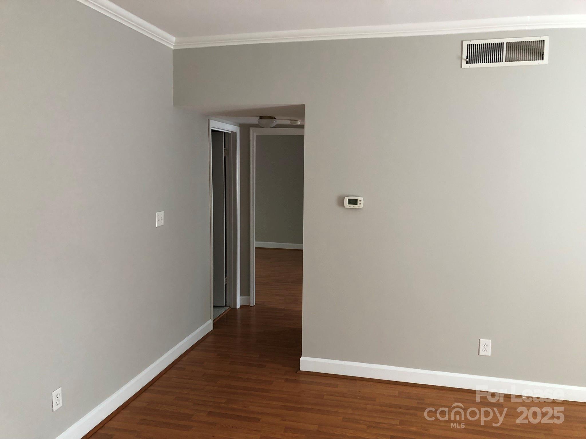 5925 Quail Hollow Road, Unit D Charlotte, NC 28210 - Photo 4 of 17 a view of an empty room with wooden floor