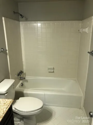 a bathroom with a toilet and a bathtub