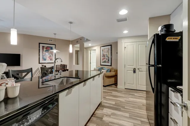 a dining room with wooden floor and large windows
