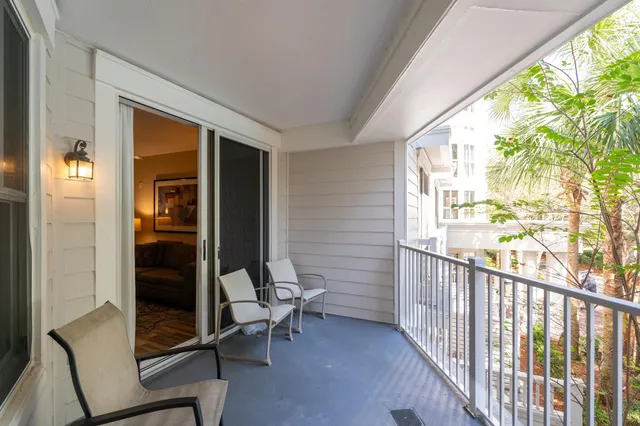 a view of a balcony with chair and front door