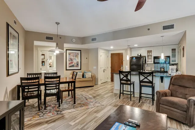 a kitchen with stainless steel appliances granite countertop a sink refrigerator and cabinets