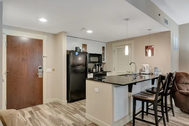 a kitchen with a refrigerator and a sink