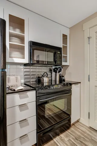 a large kitchen with a sink and refrigerator