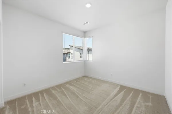 a front view of a house with glass windows and plants