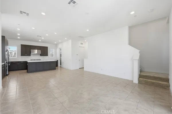 a large kitchen with stainless steel appliances kitchen island granite countertop a large counter top and oven