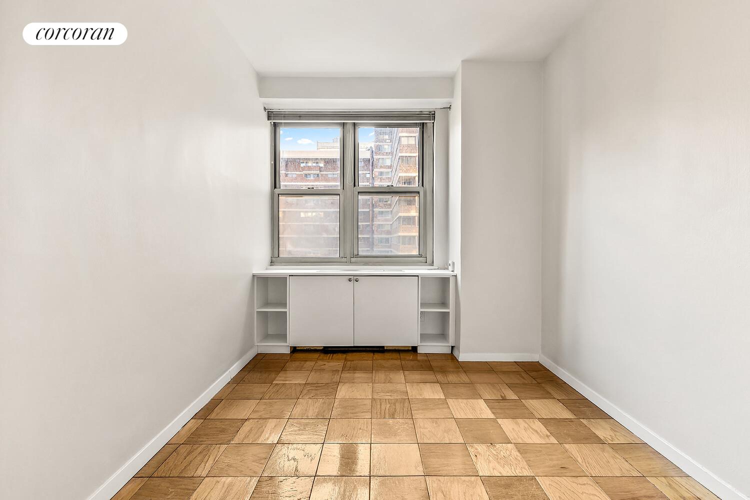 305 East 24th Street, Unit 5S Manhattan, NY 10010 - Photo 4 of 8 a view of a room with white walls and a window