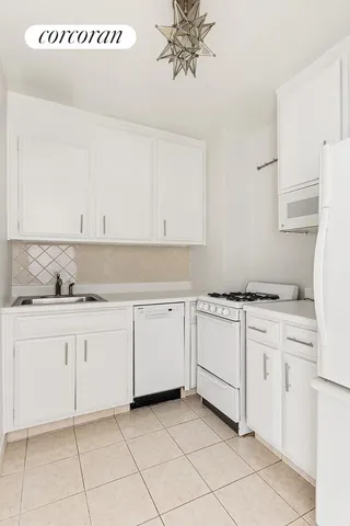 a view of a room with white walls and a window