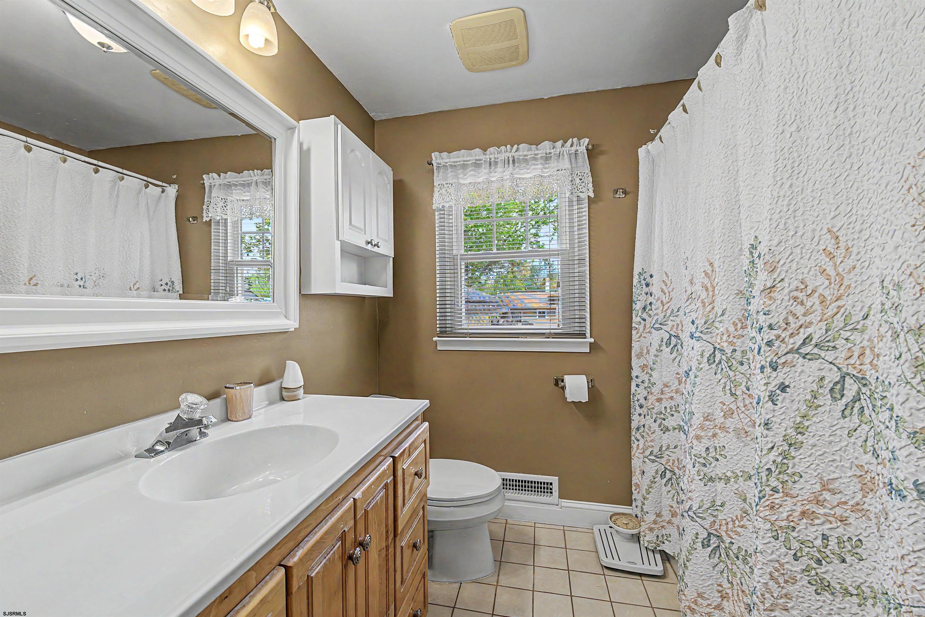125 Exton Road Somers Point, NJ 08244 - Photo 18 of 35 a bathroom with a sink a toilet and a mirror